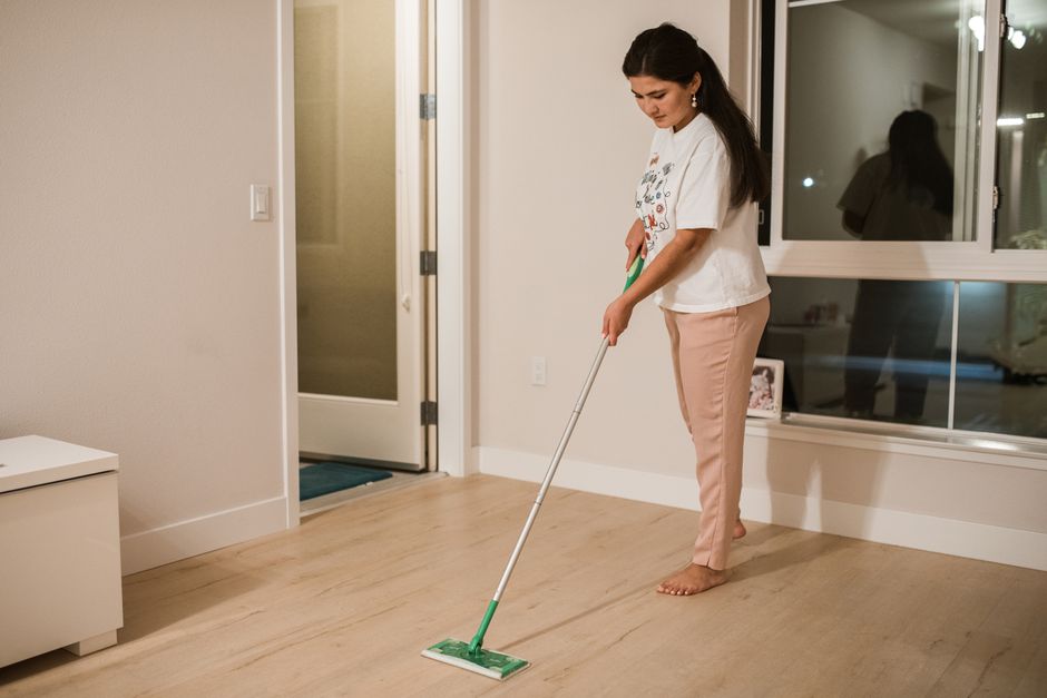 Professional mopping a pristine hardwood floor